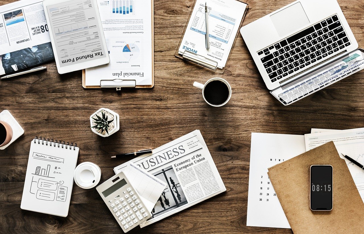 Small business workspace with laptop, documents and coffee